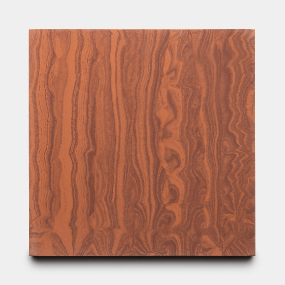 River Canyon + Rust 8x8 by Zia Tile is a square panel with a reddish-brown, wood-like pattern featuring wavy vertical lines and organic shapes on a light gray background. The surface is smooth and evenly colored.