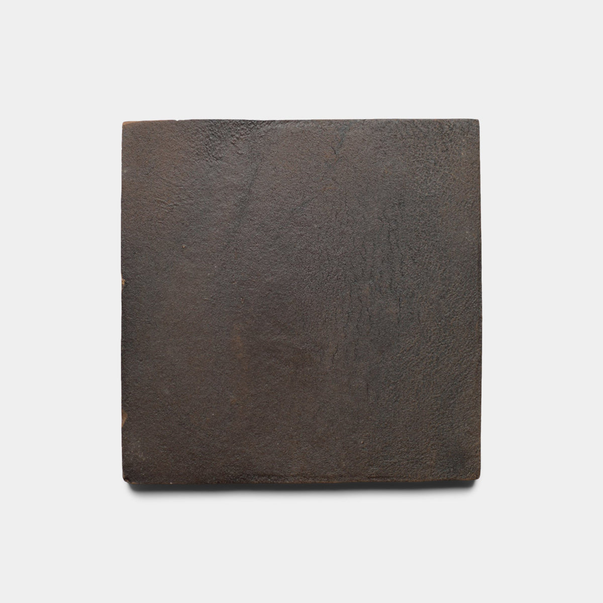 A single 8x8 Square + Oscura ceramic tile sample by Zia Tile, featuring a dark brown matte surface with slight texture, is centered on a plain white background.