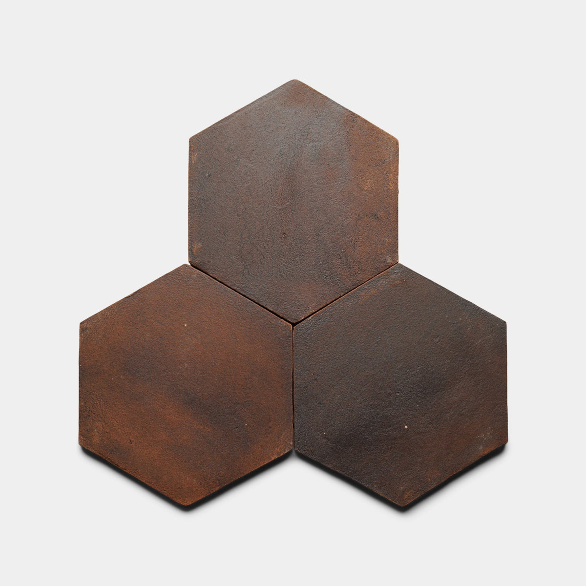 Three Zia Tile 8x9 Hex + Madera cement tile samples are arranged in a triangular cluster on a plain white background, with each handmade tile touching the others along one edge.