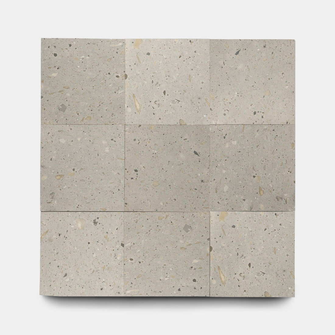 Nine Acacia 12x12 terrazzo tiles by Zia Tile, inspired by Cantera stone, display subtle beige and gray speckles and are arranged in a 3x3 grid on a plain white background.