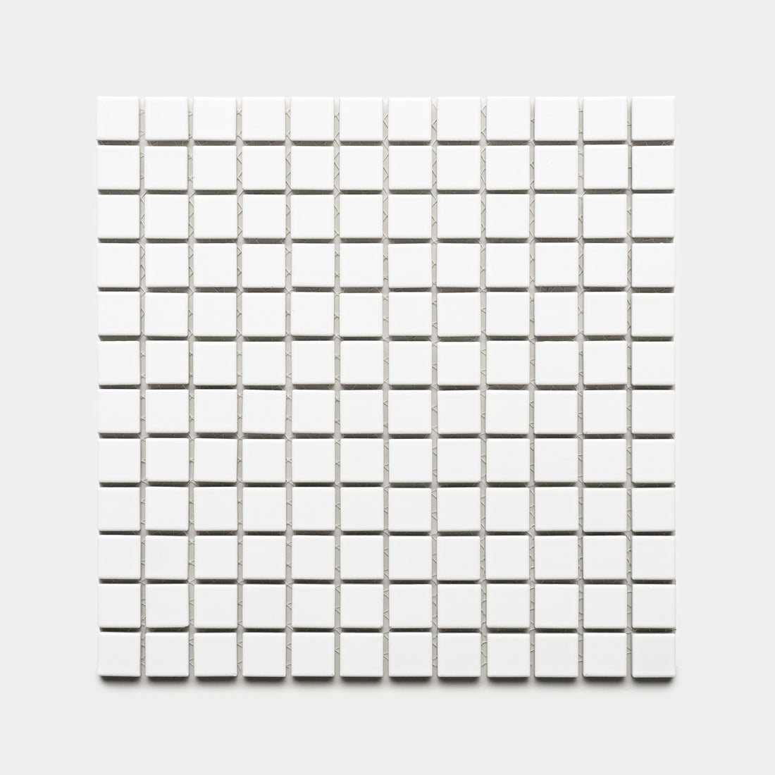 The Alabaster White 1x1 by Zia Tile features a square grid of small, evenly spaced white tiles arranged in rows and columns on a light gray background.