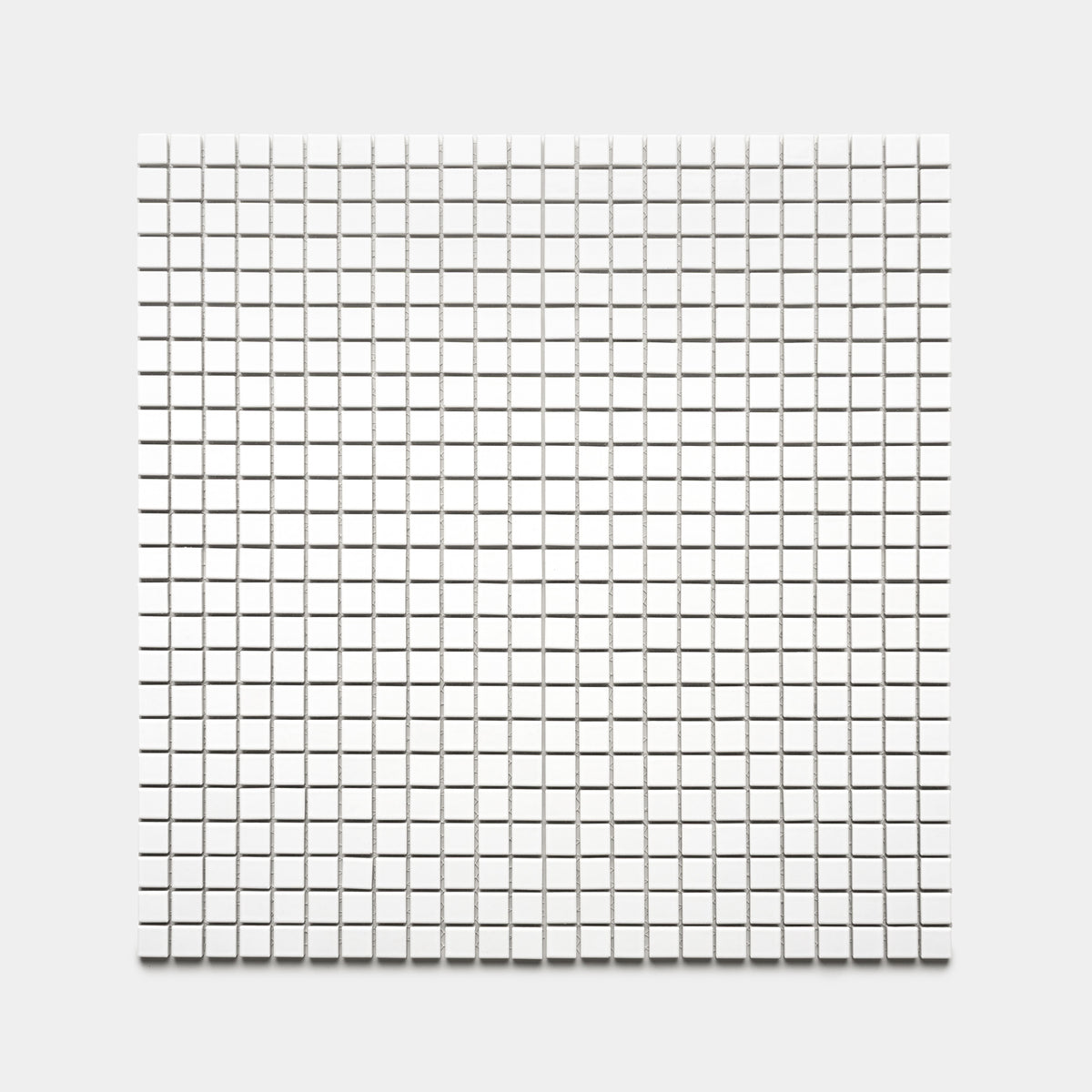 The Alabaster White 1x1 by Zia Tile features small white square tiles arranged evenly in a grid, creating a simple and geometric pattern on a light background.