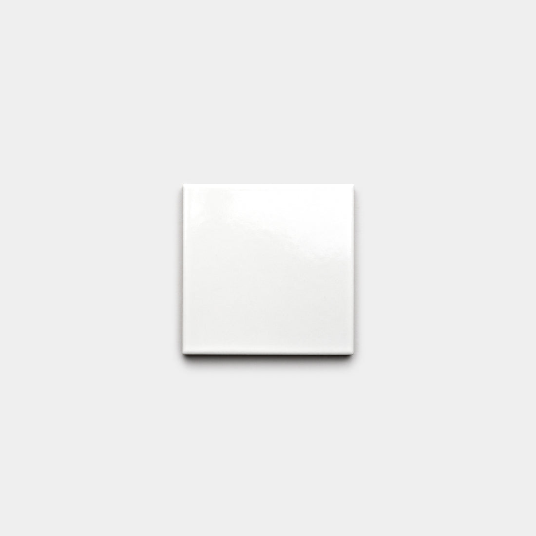 A single Alabaster White 4x4 sample tile from Zia Tile is centered on a light gray background.