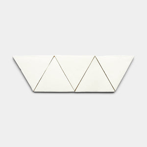 The Albar Triangle by Zia Tile features four white triangular tiles arranged in a zigzag pattern on a light gray background.