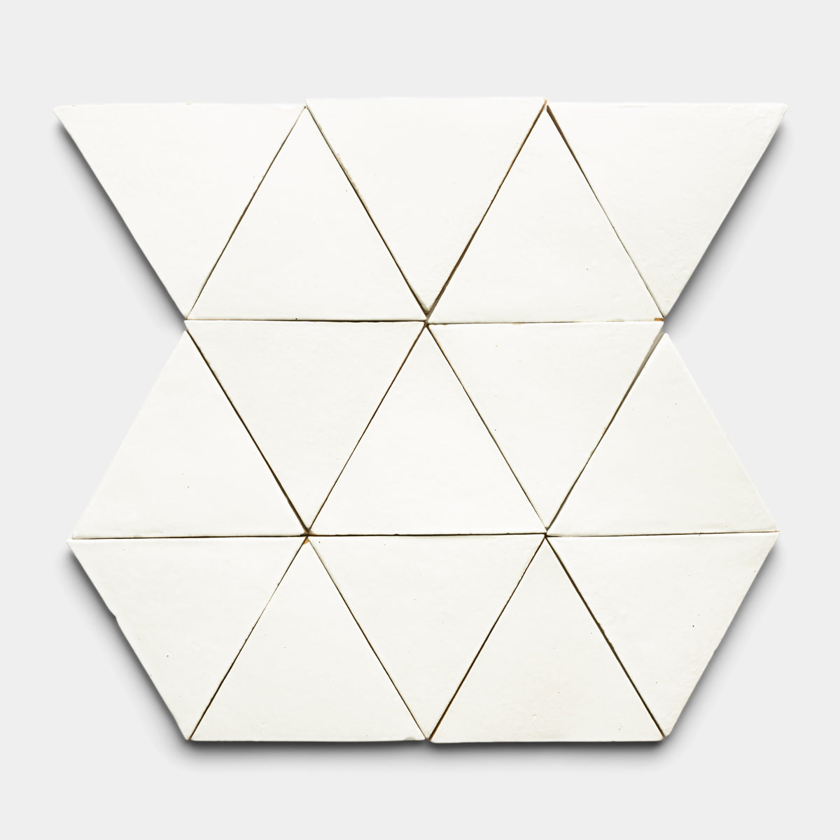 The Albar Triangle by Zia Tile features twelve white triangular pieces arranged in a hexagonal pattern on a light gray background.