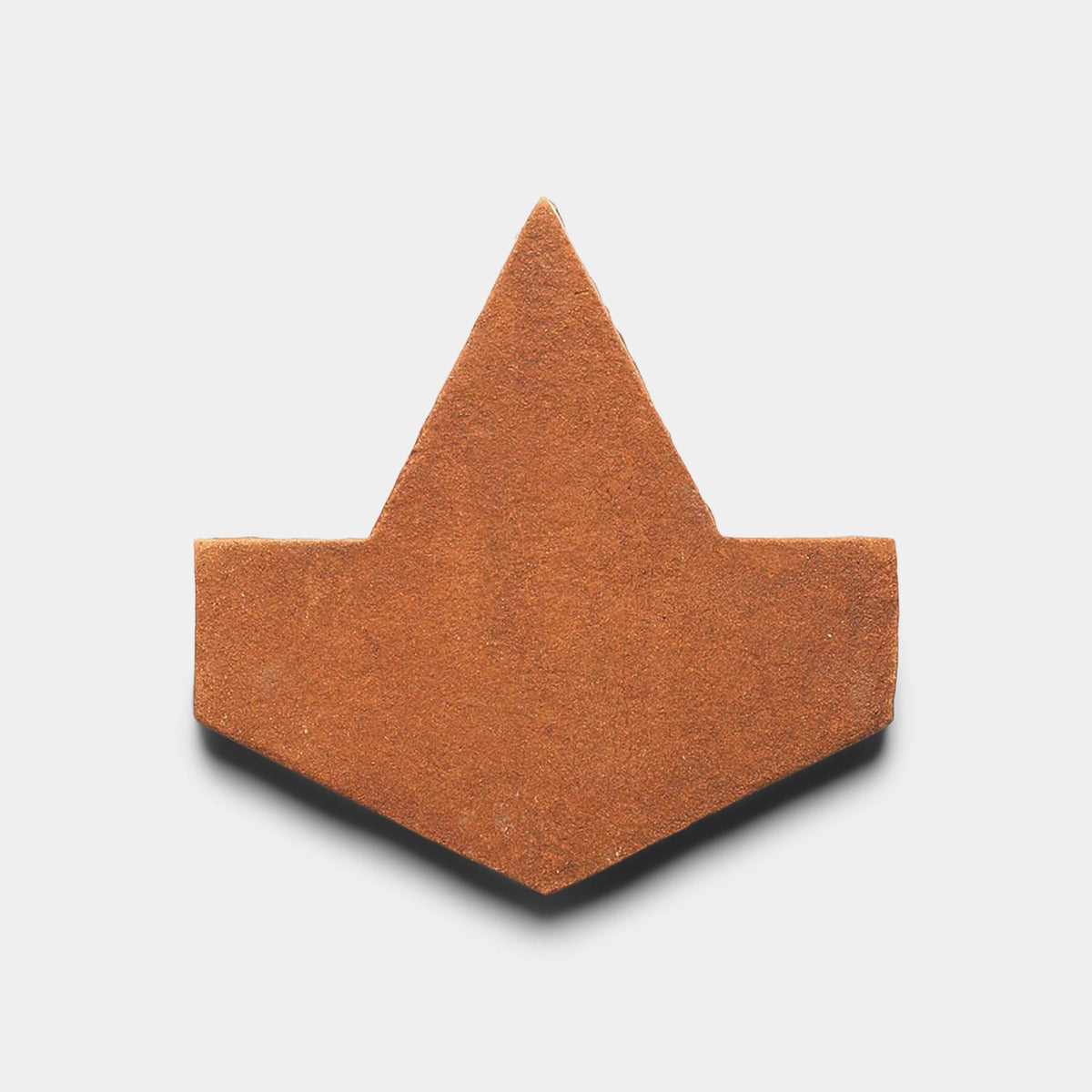 The Big Alcazar + Red Clay tile sample by Zia Tile features a single reddish-brown geometric tile with a pointed top, angled sides, and a straight base, displayed against a plain white background.