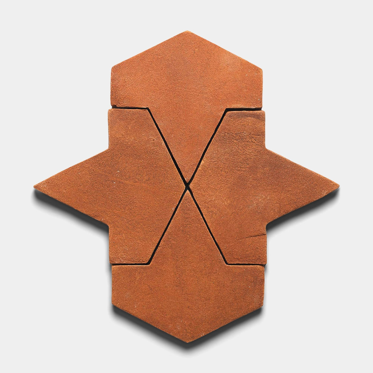 Four interlocking Big Alcazar + Red Clay tiles from Zia Tile form a symmetrical geometric hexagon with pointed extensions on opposite sides, set against a white background.