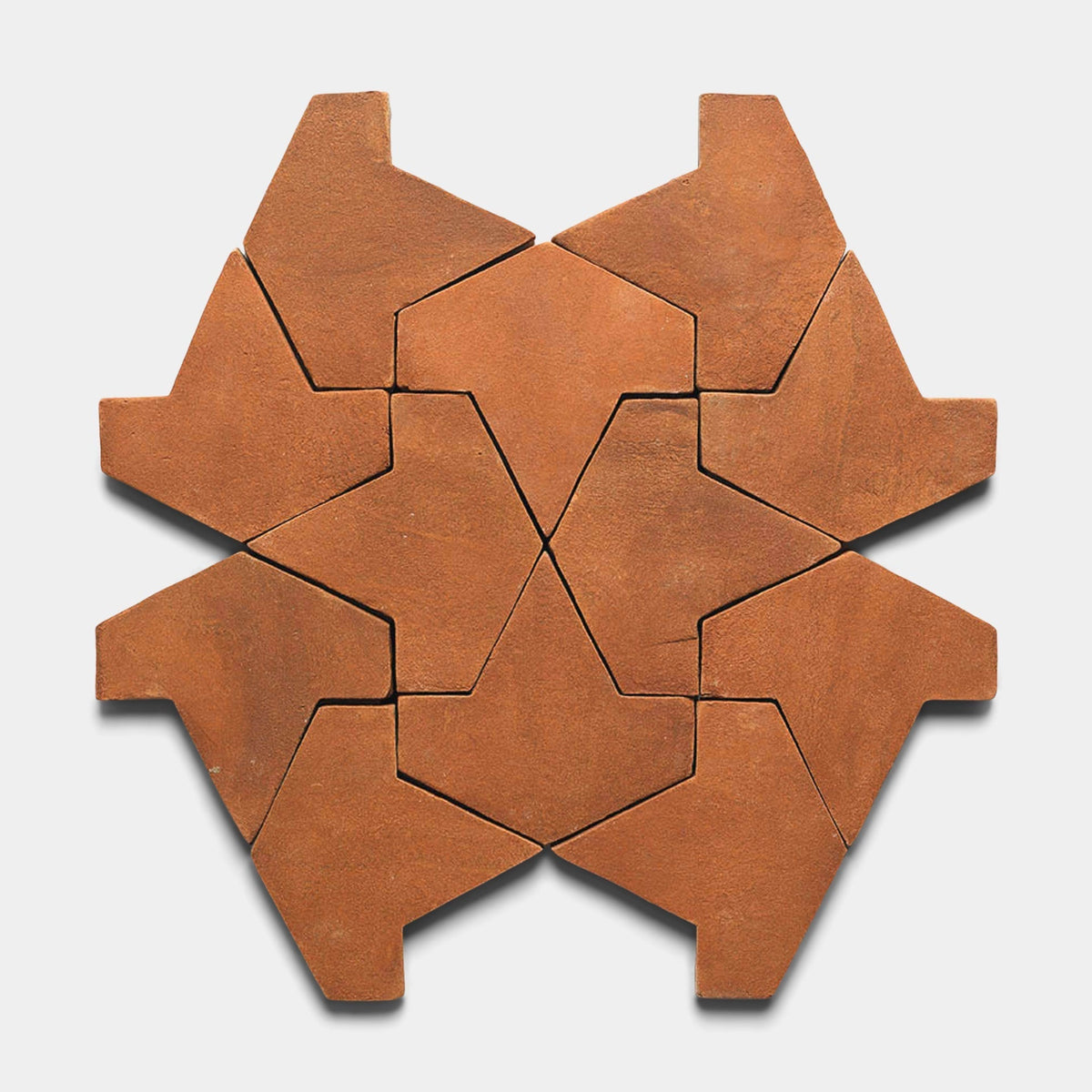 Nine Big Alcazar + Red Clay tiles by Zia Tile, in a reddish-brown hue, form an angular, star-like geometric pattern with interlocking arrow shapes on a white background.