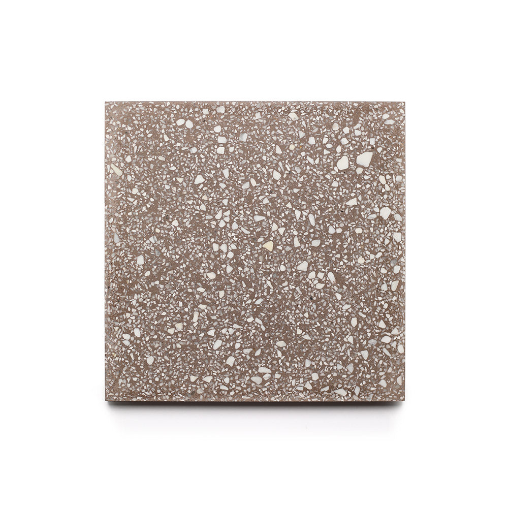 Alexander 6x6 Sample by Zia Tile: a square handmade tile with a brown background and scattered white and light gray speckles, resembling terrazzo, shown on a white surface—a testament to Zia Tile craftsmanship.