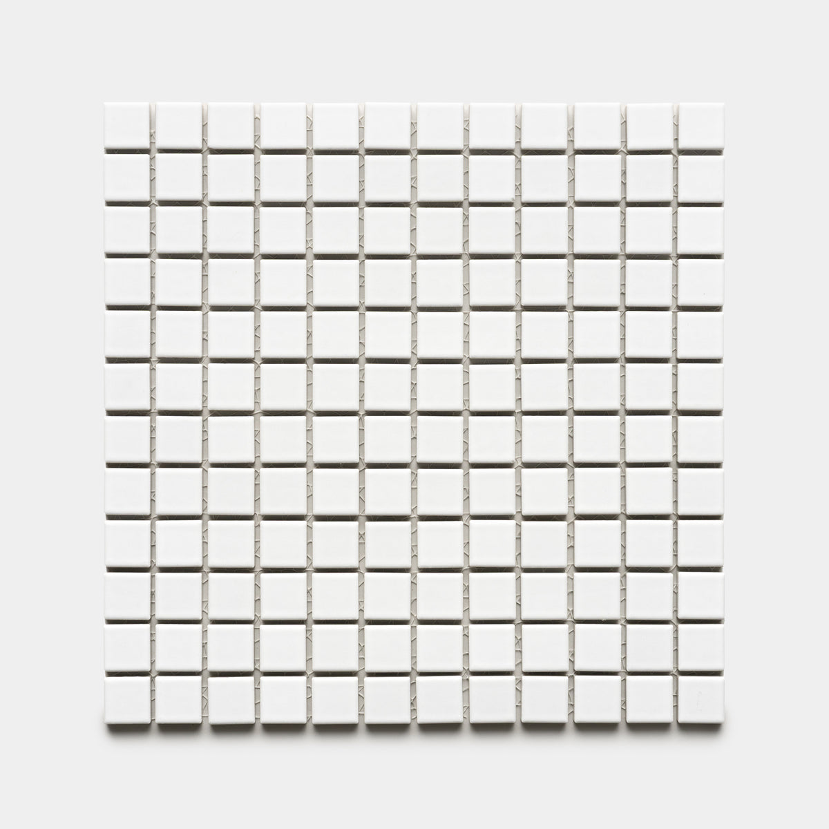 The Zia Tile Alpha White 1x1 features a grid of small, evenly spaced white square tiles arranged in rows and columns on a light gray background.