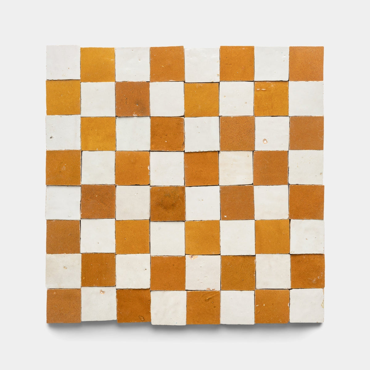 The Amber + Casablanca Checkerboard Sample by Zia Tile features alternating glossy white and matte orange-brown handmade tiles in a square checkerboard pattern, arranged evenly on a plain white background.