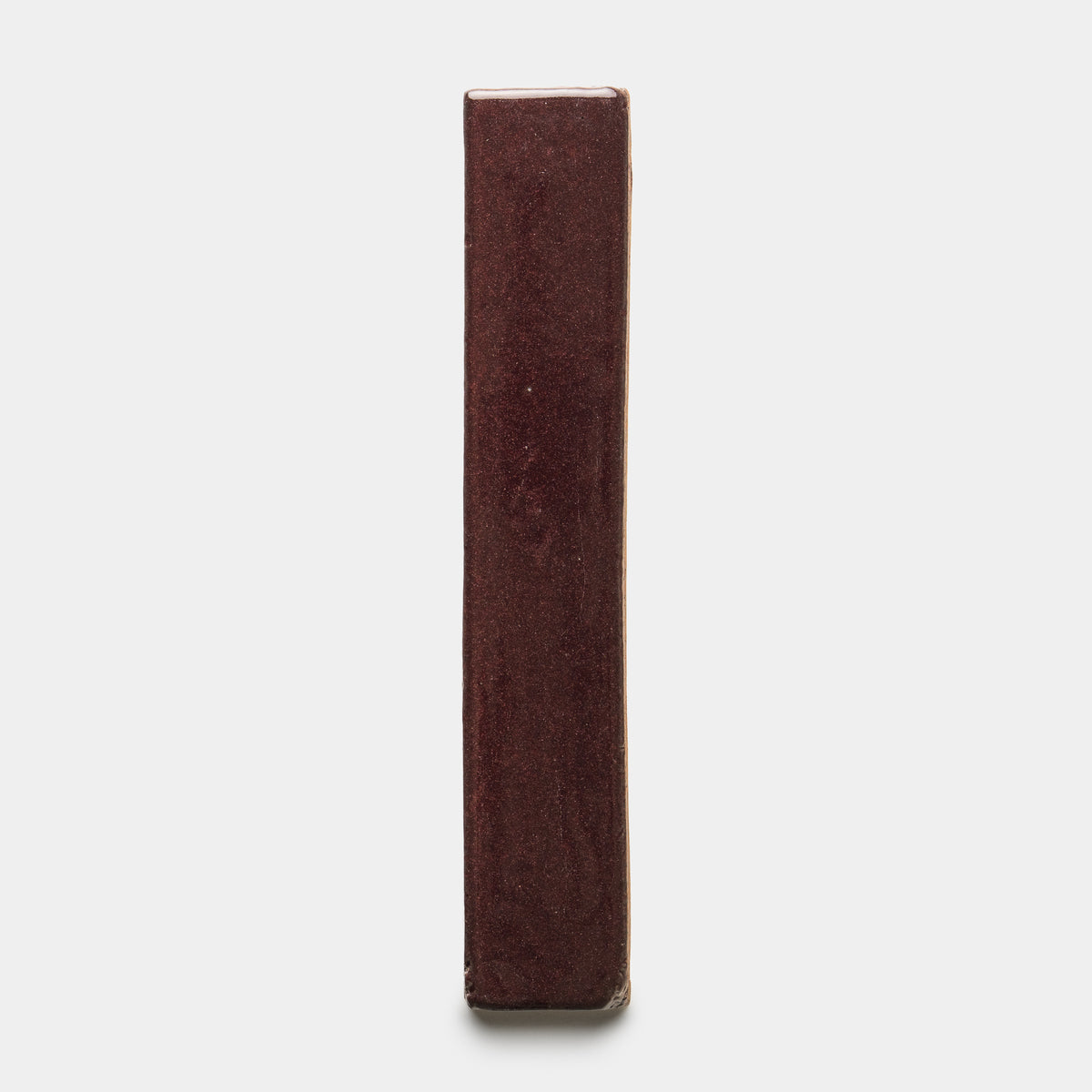 The Zia Tile Ancho Mini Bar is a rectangular solid block with a smooth, glossy, dark reddish-brown surface, shown standing upright against a plain white background.