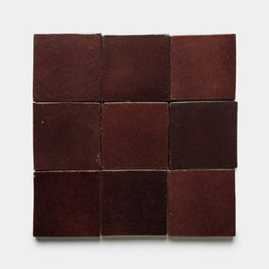 Nine Ancho 4x4 Square matte dark red ceramic tiles by Zia Tile are arranged in a 3x3 grid on a plain white background.