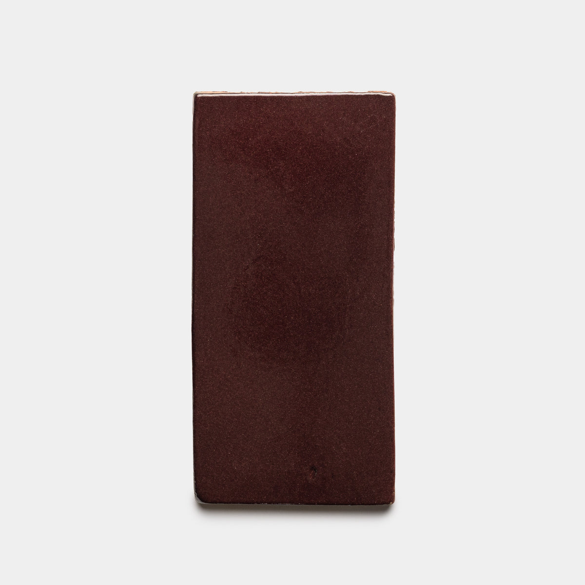 The Zia Tile Ancho 4x8 Rectangle is a rectangular, dark reddish-brown brick shown standing upright against a white background.