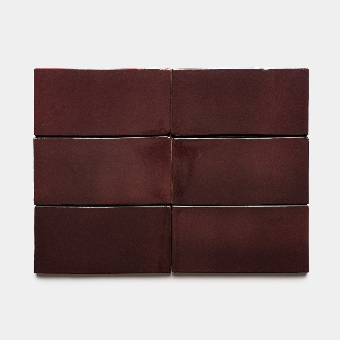 Six glossy maroon Zia Tile Ancho 4x8 Rectangle tiles are arranged in two rows of three against a plain white background.
