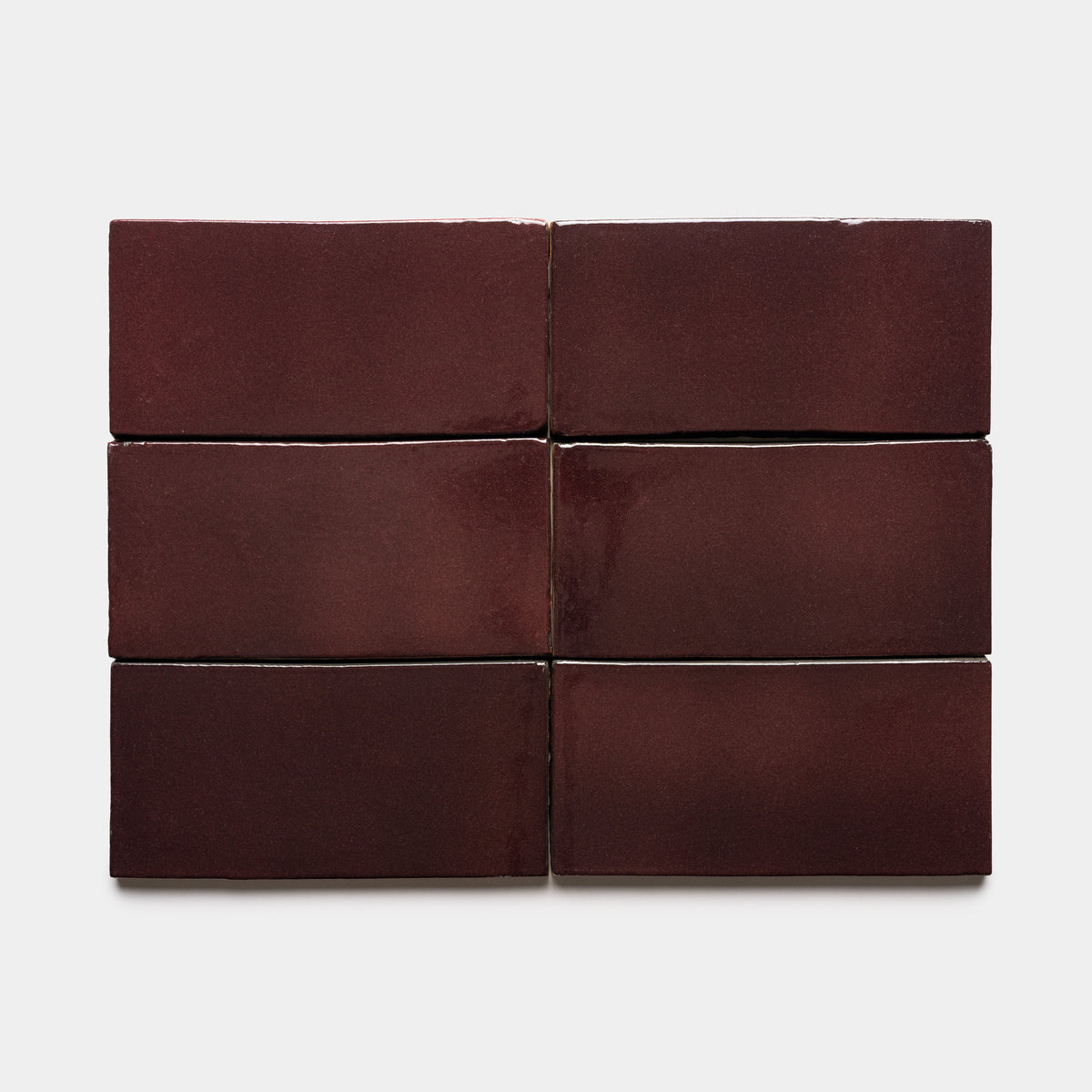Six glossy maroon Zia Tile Ancho 4x8 Rectangle tiles are arranged in two rows of three against a plain white background.