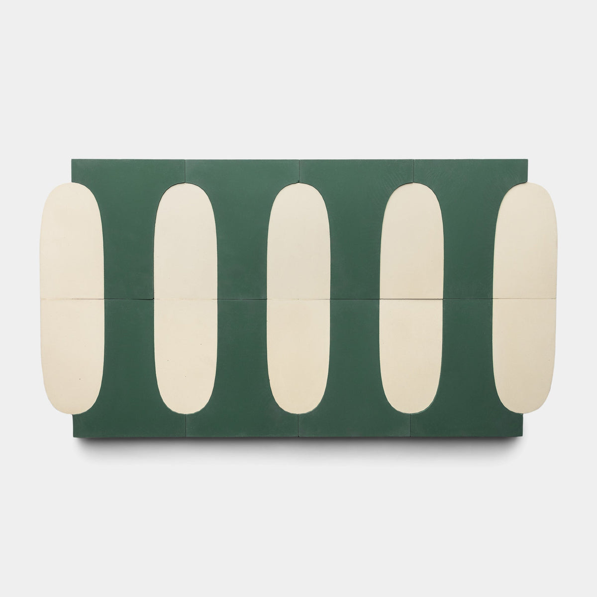 The Zia Tile Arco Noble Green + Bone sample features a repeating geometric pattern with five elongated cream ovals vertically aligned on a green background, perfect for fans of handmade cement tile designs.