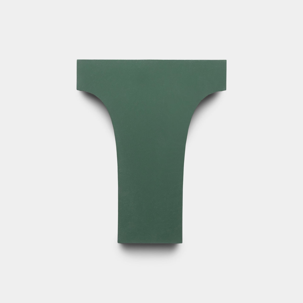 The Arco Noble Green + Bone sample by Zia Tile is a green, T-shaped handmade tile with broad top edges and a narrow base, shown against a plain white background.