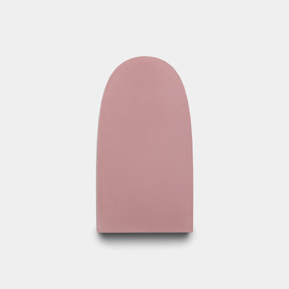 The Arco Protea + Canyon sample by Zia Tile is a pink, smooth, upright oval tile with a flat bottom, shown against a plain white background.