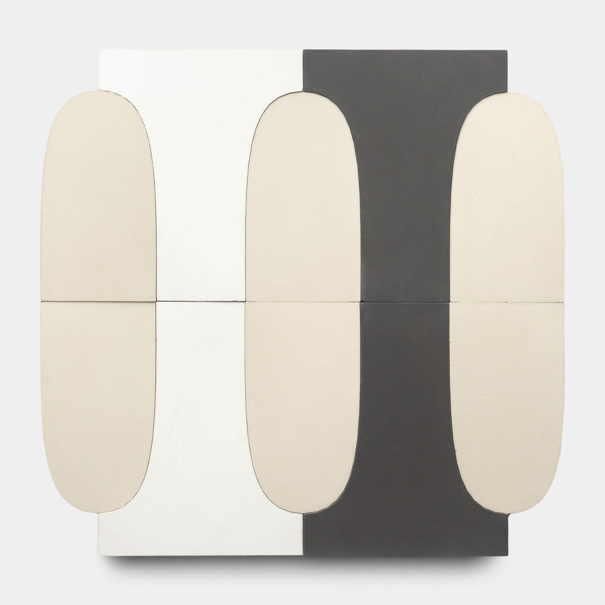 The Arco White + Black + Bone sample by Zia Tile showcases abstract, handmade tile design with four rounded beige shapes in two rows on a split black and white background, forming a strikingly symmetrical composition.