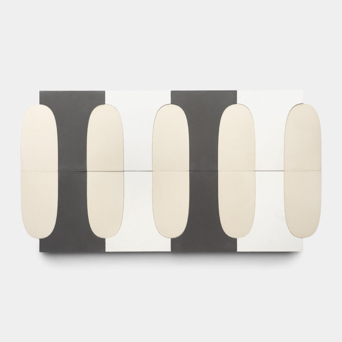 The Arco White + Black + Bone Sample by Zia Tile is a rectangular modular sideboard with alternating black, white, and gray vertical panels and rounded cream doors reminiscent of handmade tile, shown from above on a plain white background.