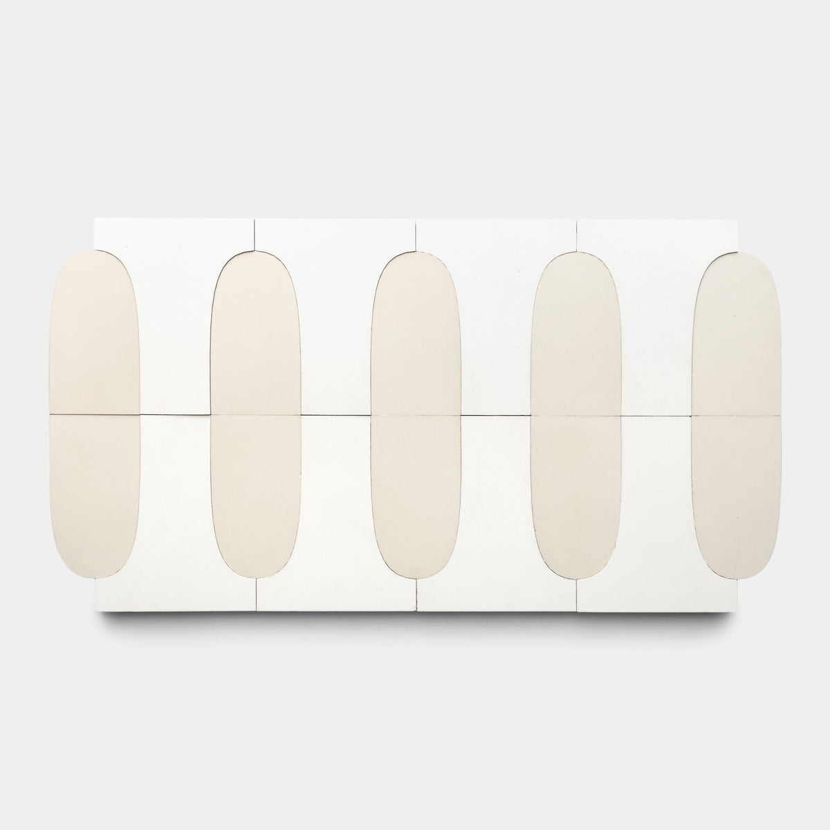 The Arco White + Bone Sample by Zia Tile features a minimalist rectangular white table showcasing six rounded beige handmade tiles in two rows of three, viewed from above against a plain white background.