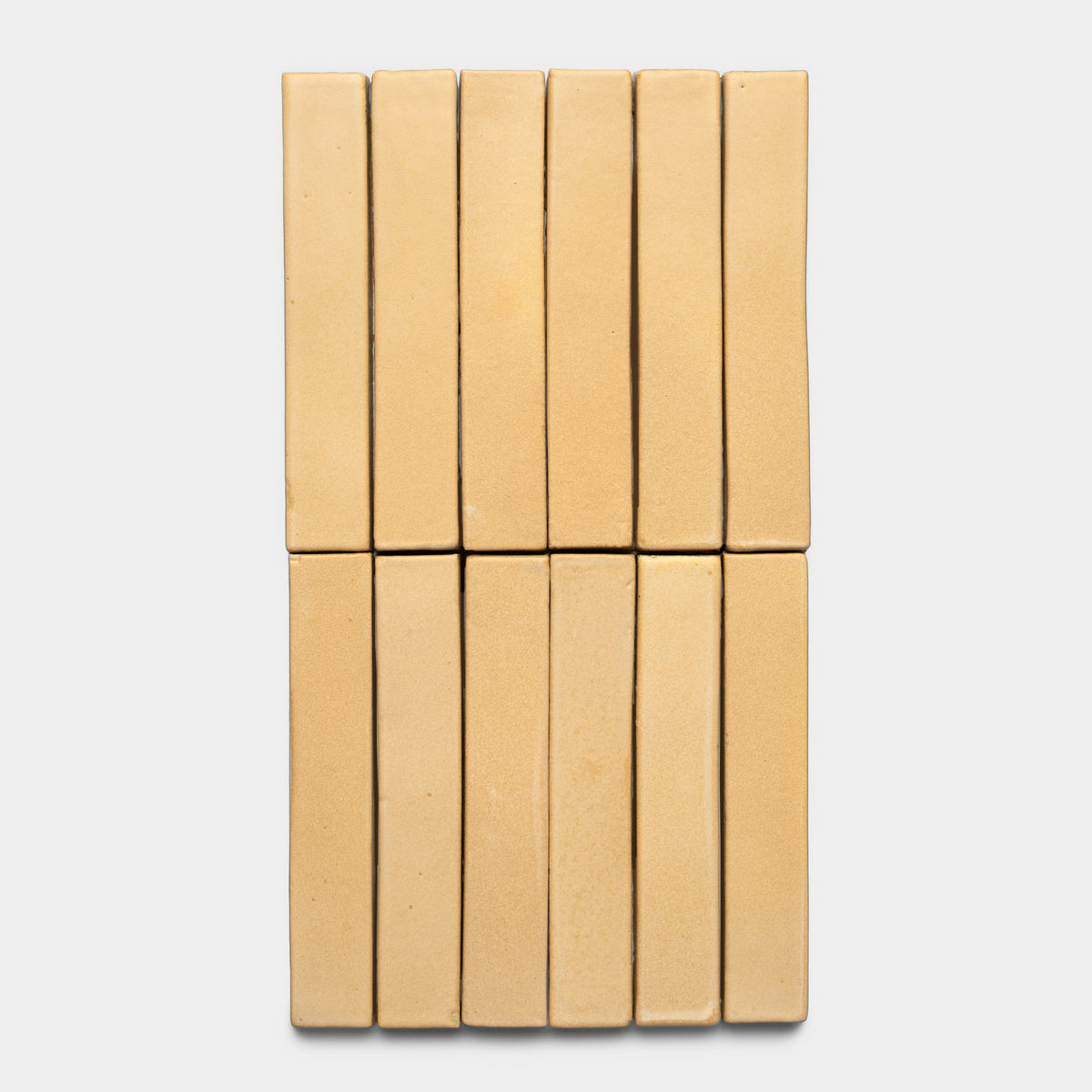 Twelve Arroyo Mini Bar cookies by Zia Tile, rectangular and beige, arranged in two rows of six on a plain white background.