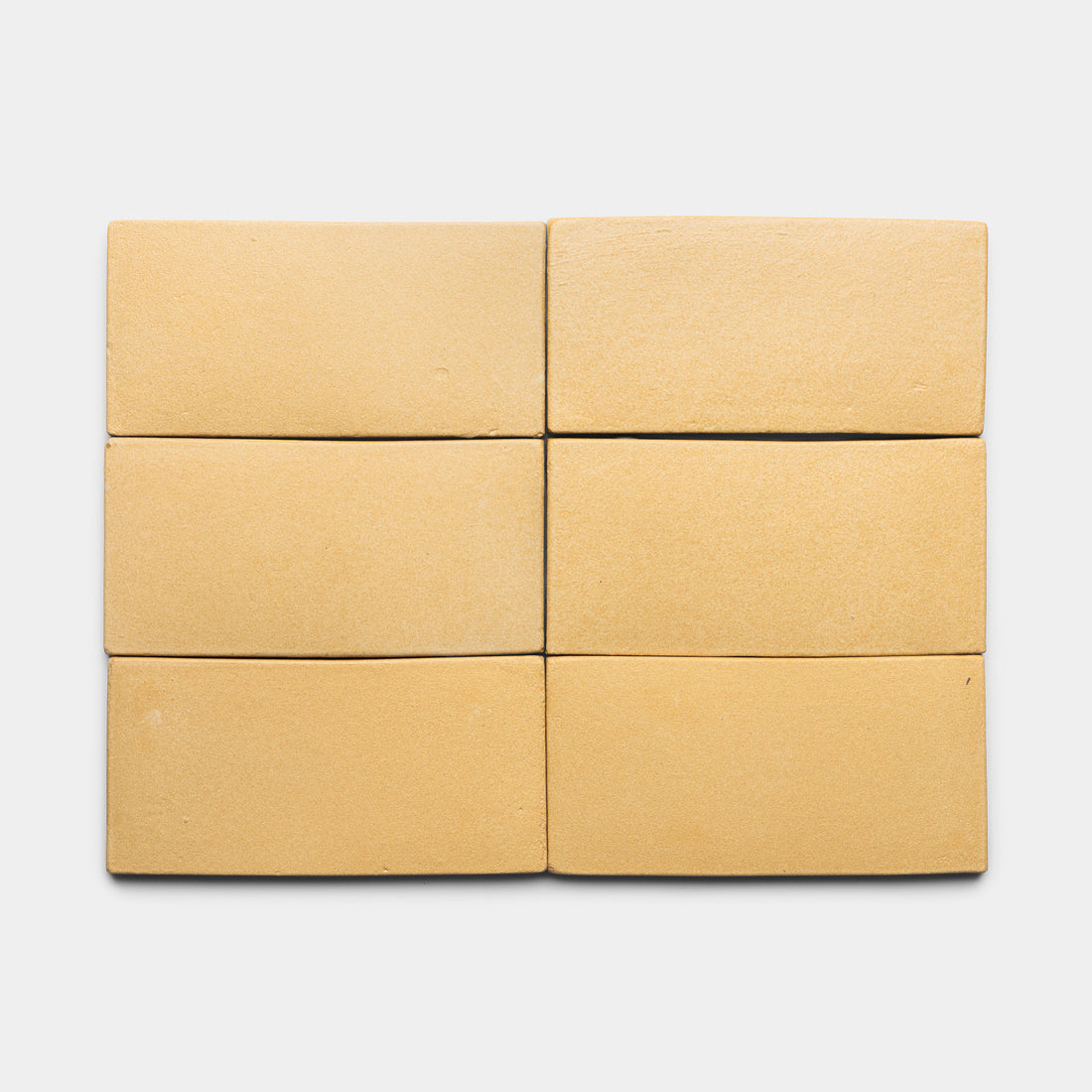 Six Arroyo 4x8 Rectangle tiles by Zia Tile, in light tan, are arranged in two rows of three on a plain white background.