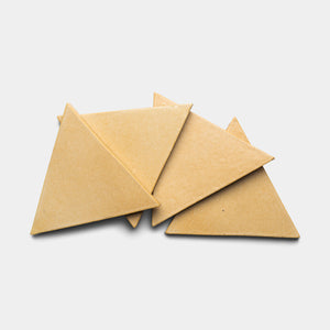 Four Arroyo Triangle tiles by Zia Tile, in a plain tan color, are overlapping each other on a white background.