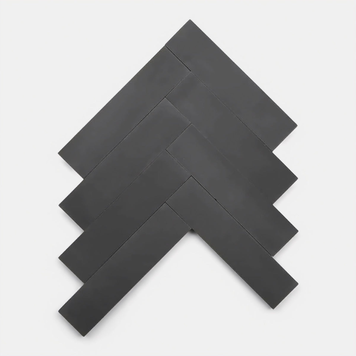 Five Ash 2x8 tiles from Zia Tile are arranged in a herringbone pattern on a white background, forming a geometric, arrow-like shape.