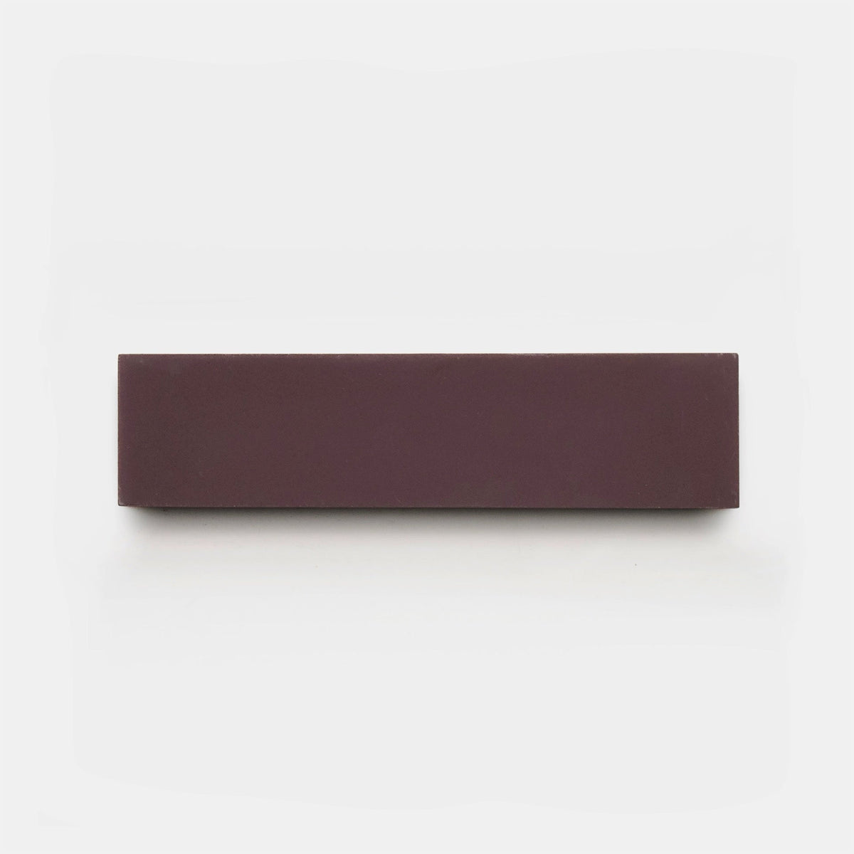 A rectangular, dark brown Aubergine 2x8 tile by Zia Tile is centered on a plain white background.