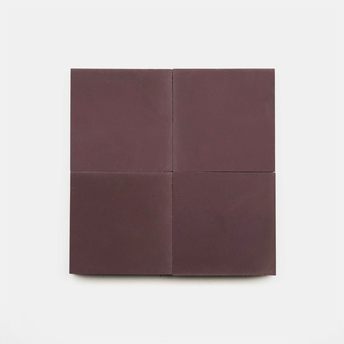 Four square Aubergine 4x4 matte tiles by Zia Tile are arranged two-by-two on a plain white background.