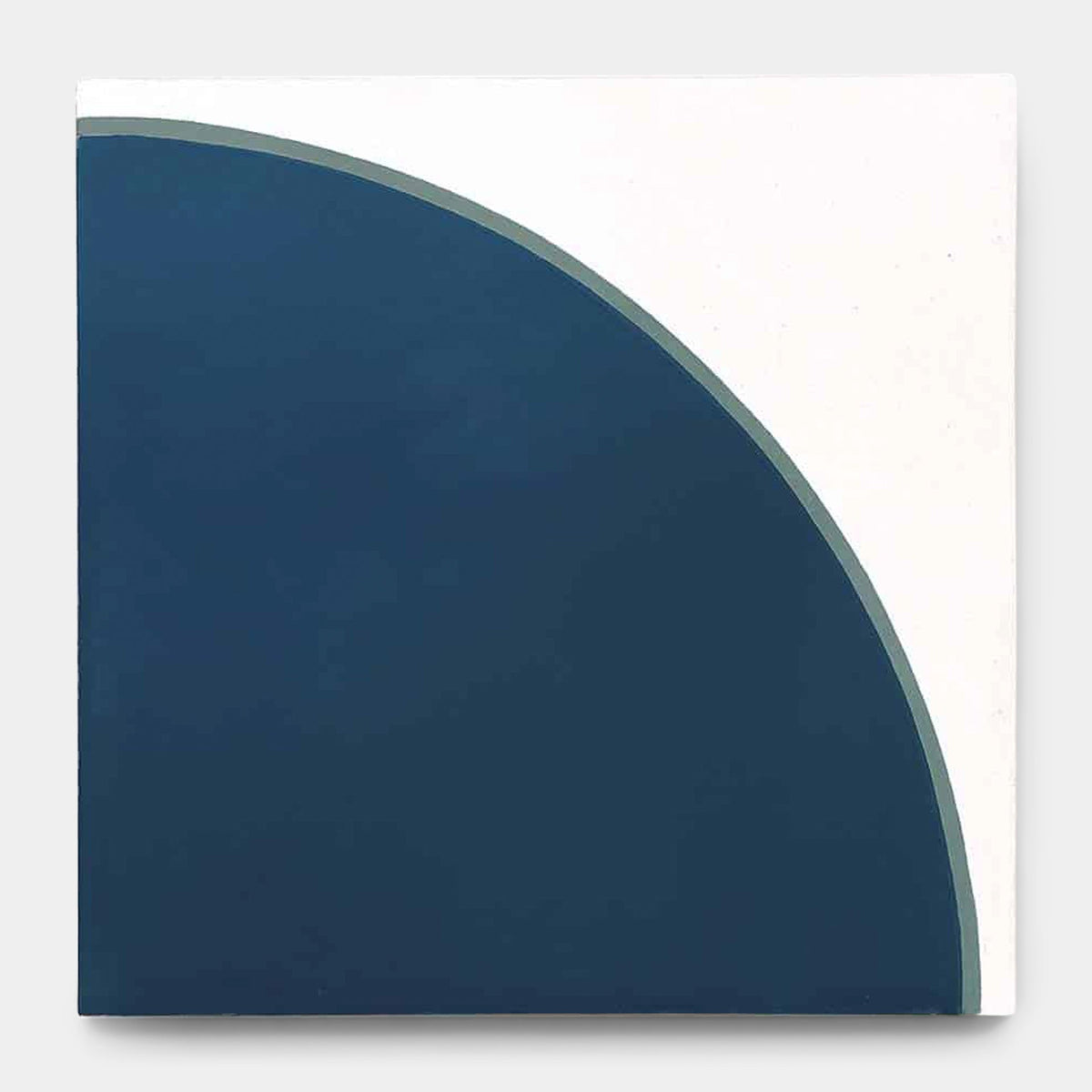 The Avalon Midnight 8x8 Sample by Zia Tile features a square design inspired by handmade tiles, with a large navy blue semi-circle in the lower left, a thin gray border curve, and a crisp white background for a modern geometric look.
