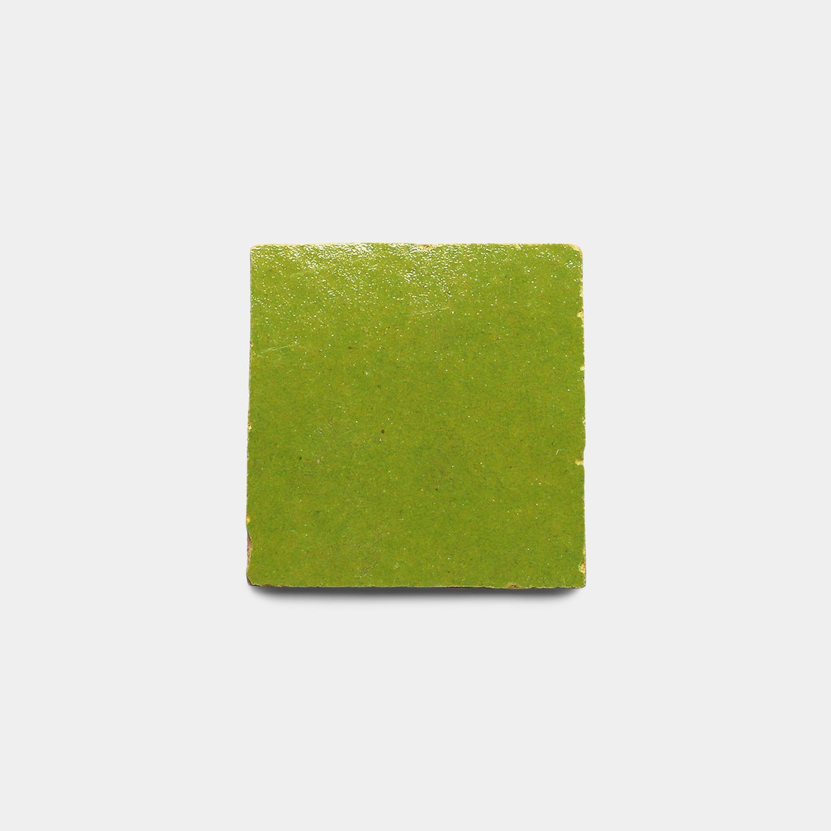 The Avocado 2x2 Sample by Zia Tile is a square ceramic tile with a glossy, bright green finish, displayed against a plain white background.