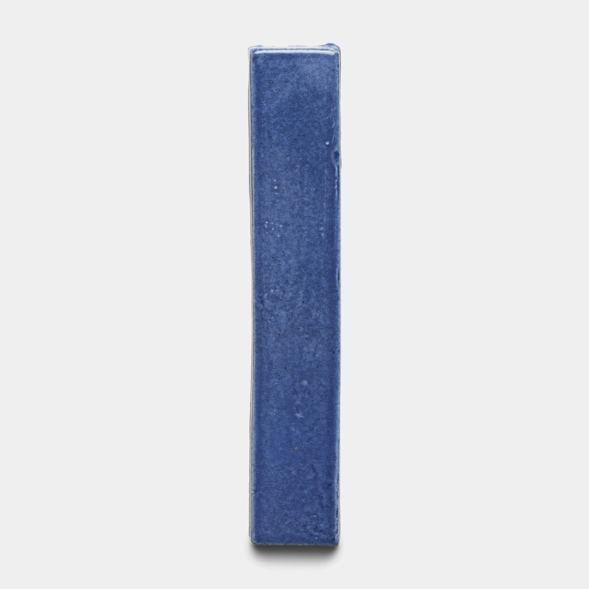 The Zia Tile Azul Mini Bar, a single rectangular blue tile, stands upright against a plain white background.