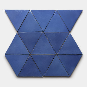 The Azul Triangle by Zia Tile features twelve blue ceramic triangles arranged in two rows of connected hexagons on a light gray background.