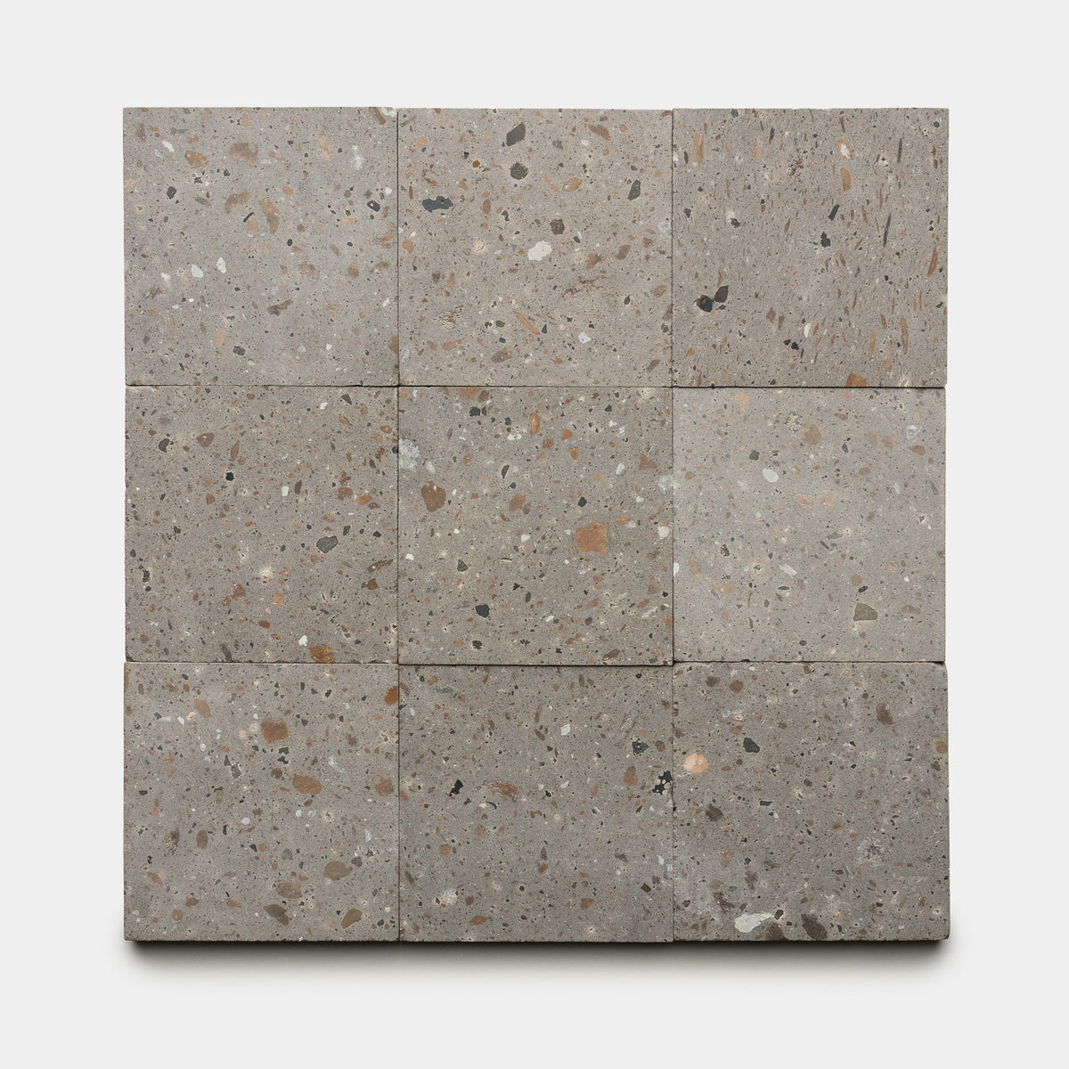 Nine Badlands 6x6 terrazzo tiles by Zia Tile, featuring gray tones with brown, tan, and black stone chips, are arranged in a 3x3 grid on a white background.