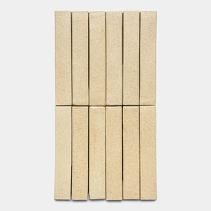 Twelve Zia Tile Baja Mini Bar beige rectangular tiles are arranged vertically in two rows of six against a plain white background.