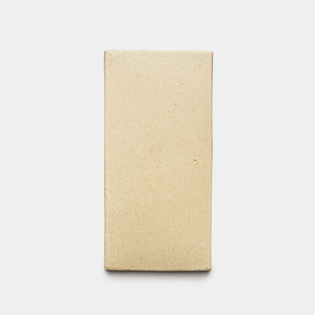 The Zia Tile Baja 4x8 Rectangle, a rectangular beige unglazed ceramic tile with a smooth surface, is centered on a plain white background.