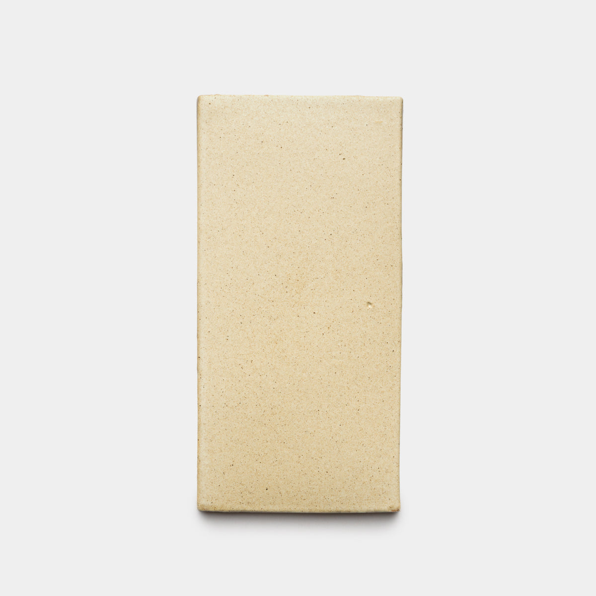 The Zia Tile Baja 4x8 Rectangle, a rectangular beige unglazed ceramic tile with a smooth surface, is centered on a plain white background.