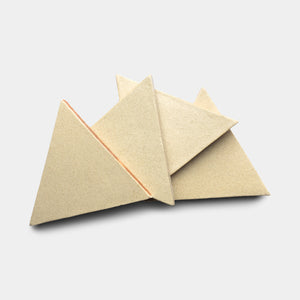 Four Baja Triangle tiles by Zia Tile, in beige, are arranged in an overlapping pattern on a light gray background.