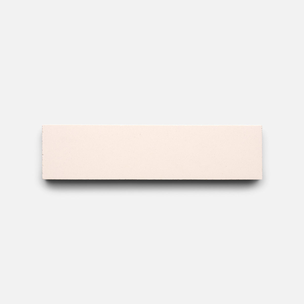 A Ballet Slipper 2x8 tile sample by Zia Tile, rectangular and light beige, is centered on a white background.