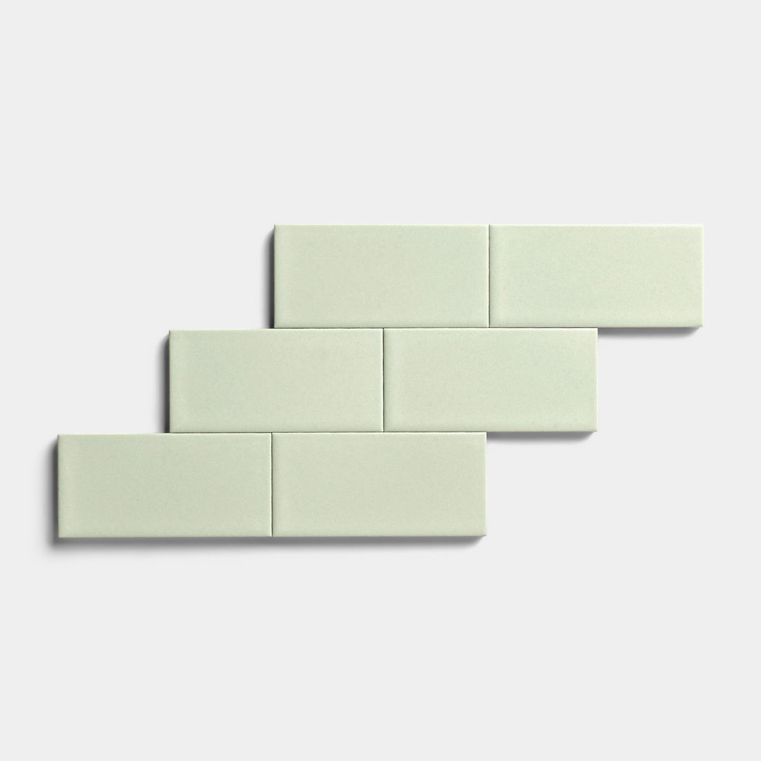 Five Balsam 2x4 rectangular tiles by Zia Tile with a matte finish are arranged in a staggered, brick-like pattern on a plain white background, highlighting their versatility for indoor and outdoor use.