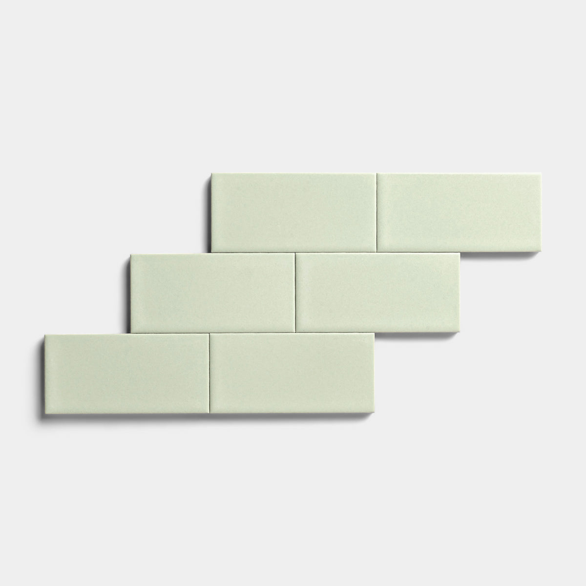 Five Balsam 2x4 rectangular tiles by Zia Tile with a matte finish are arranged in a staggered, brick-like pattern on a plain white background, highlighting their versatility for indoor and outdoor use.