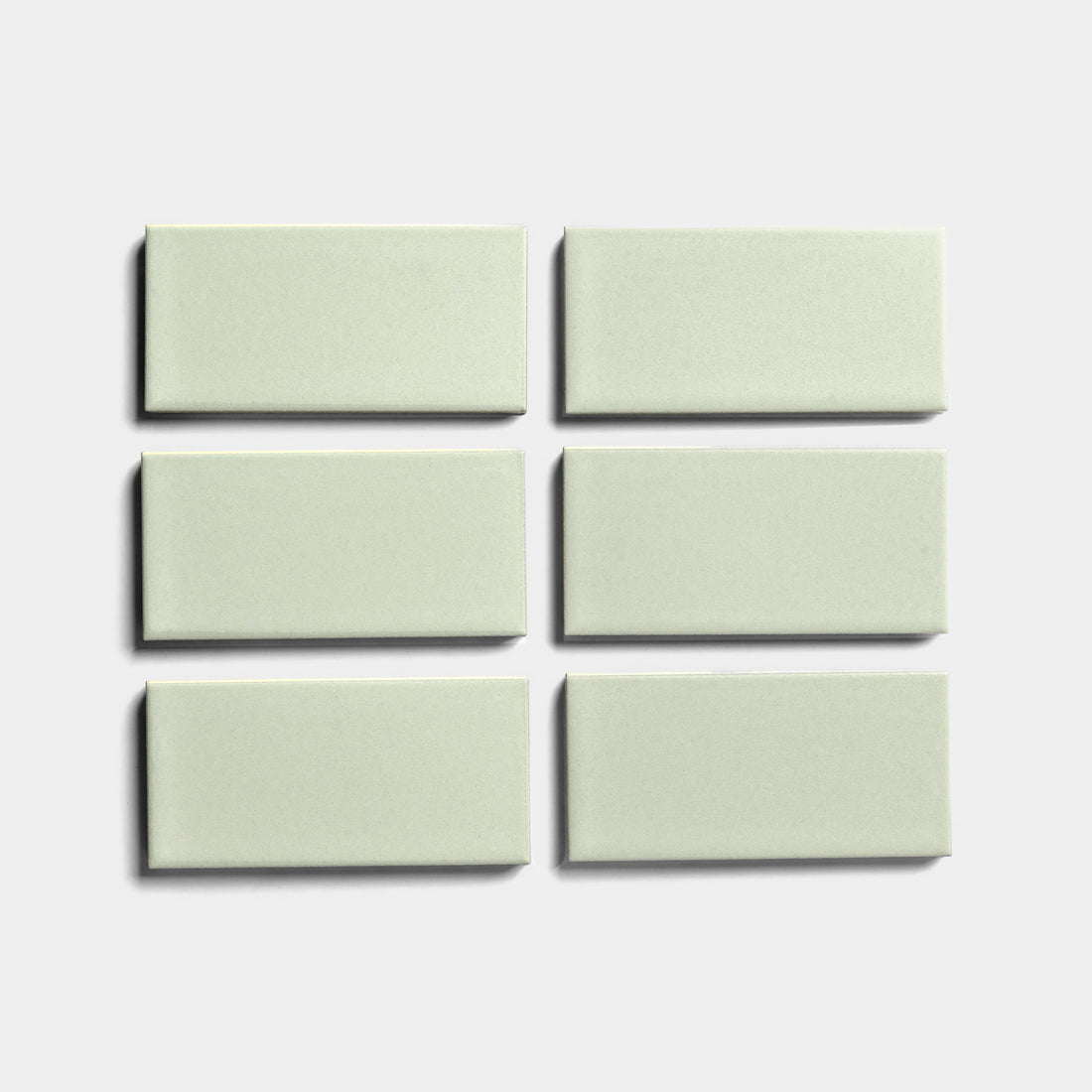Six Balsam 2x4 rectangular ceramic tiles by Zia Tile, in light gray architectural grade, are arranged in two rows of three on a plain white background—perfect for indoor or outdoor installations.