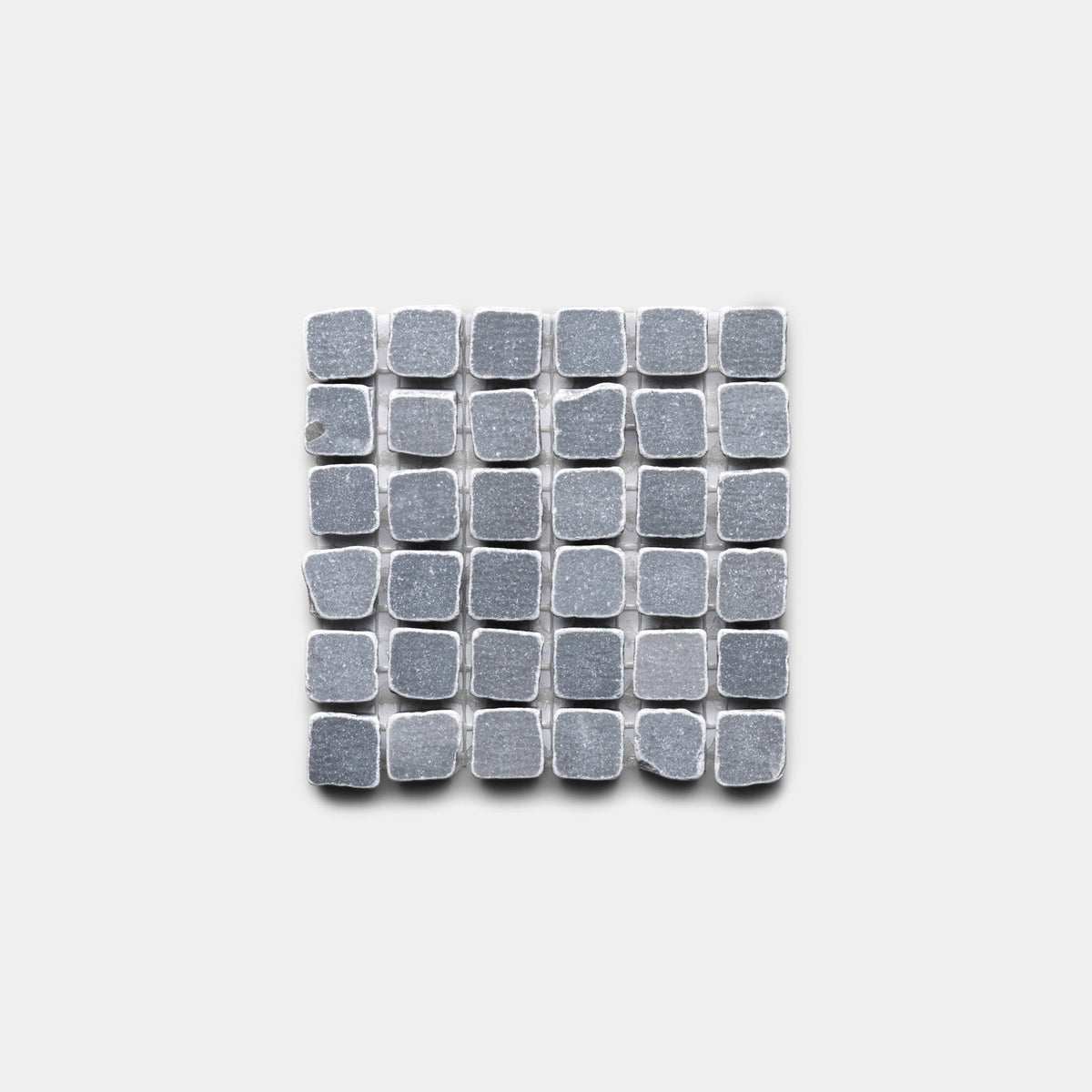 A grid of small, square Ventaglio in Bardiglio Imperiale tiles by Zia Tile is arranged in a square pattern on a plain light gray background.