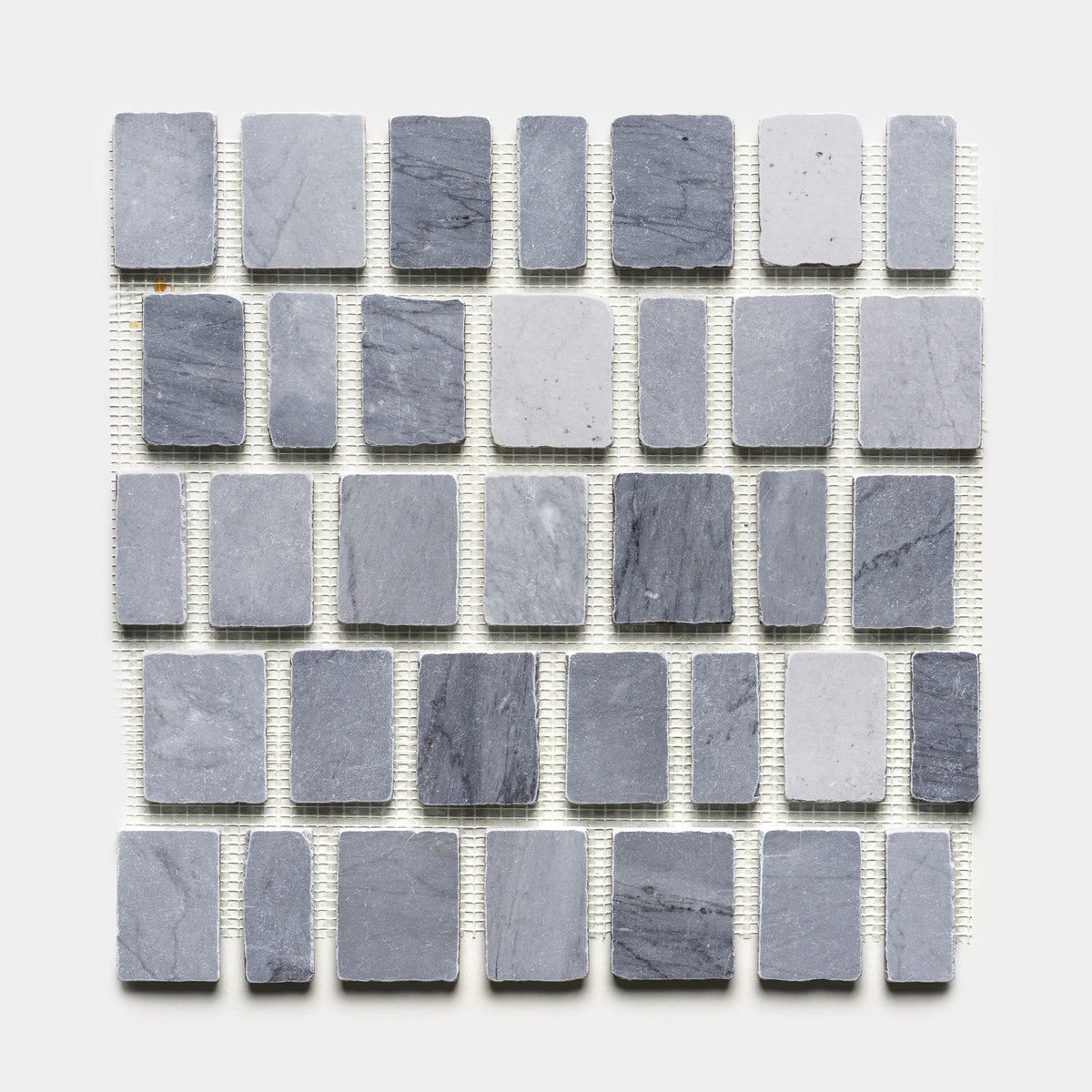 The Scarpa in Bardiglio Imperiale by Zia Tile is a square sheet showcasing an alternating pattern of small and large gray rectangular and square stone tiles, neatly arranged in horizontal rows on a white background.