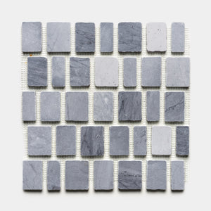 The Scarpa in Bardiglio Imperiale by Zia Tile is a square sheet showcasing an alternating pattern of small and large gray rectangular and square stone tiles, neatly arranged in horizontal rows on a white background.