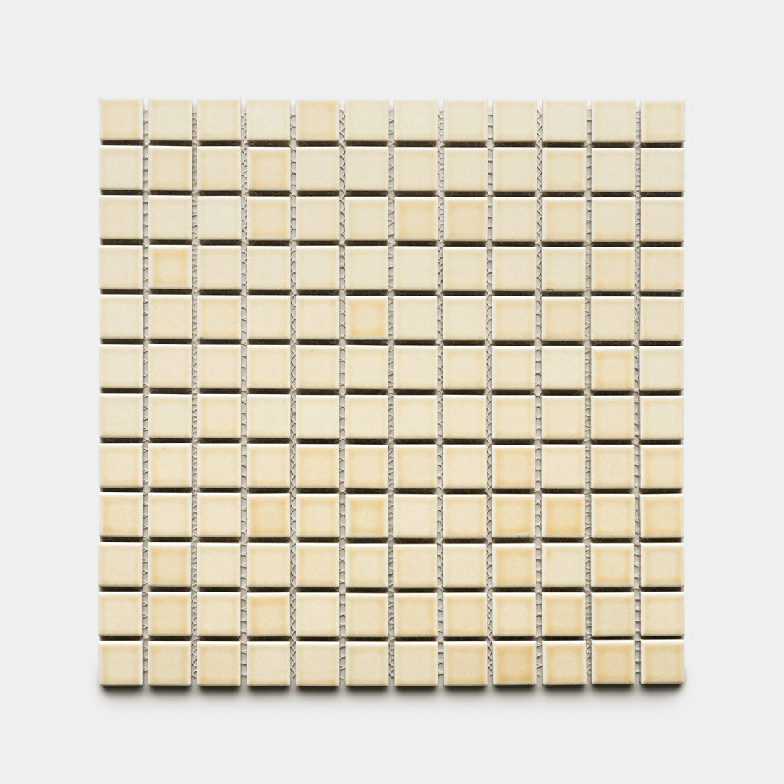 The Birch 1x1 by Zia Tile features small, square, beige ceramic tiles arranged evenly on a white background, creating a mosaic tile sheet effect.