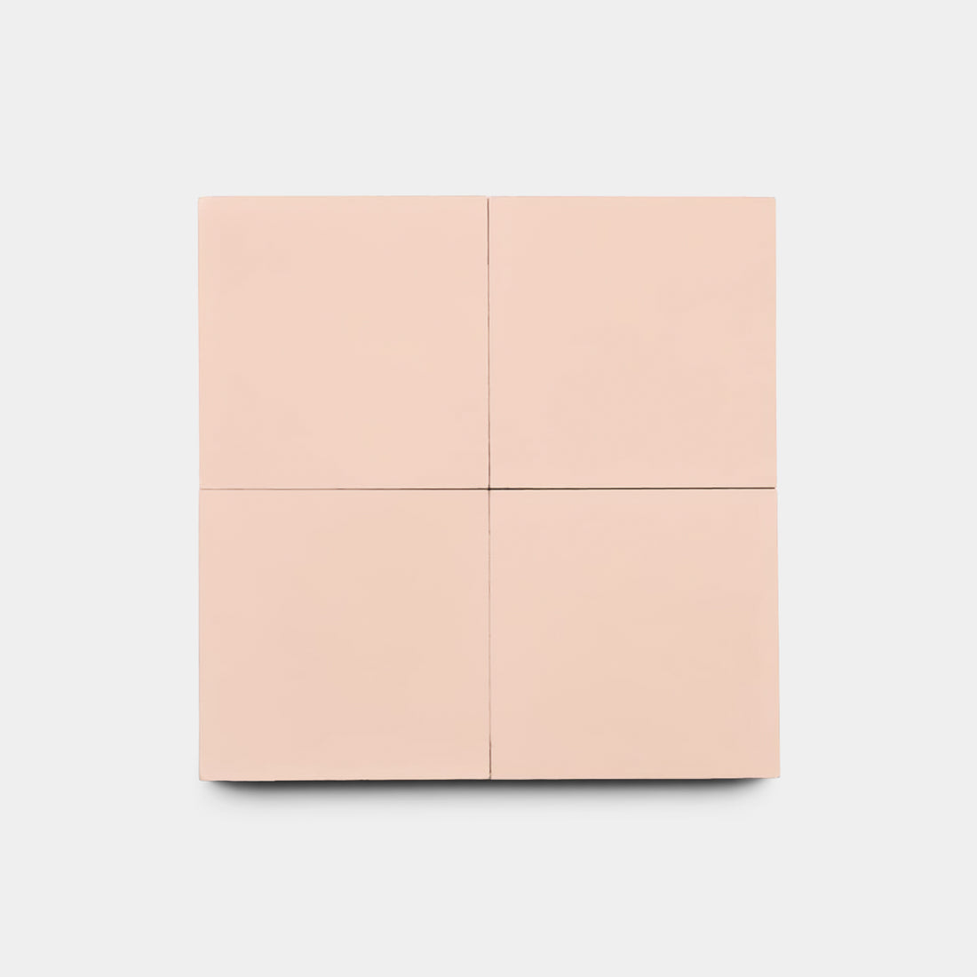 A minimalist, pale pink square cabinet with four panels stands against a white background, reflecting the modern elegance of Zia Tile's Bisbee Pink 4x4 tiles, often chosen for chic kitchen backsplashes.